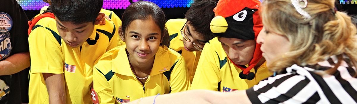 Smiling kids at FIRST LEGO League table